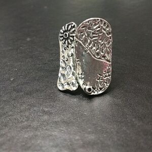 Silver tone abstract ring with textured flower